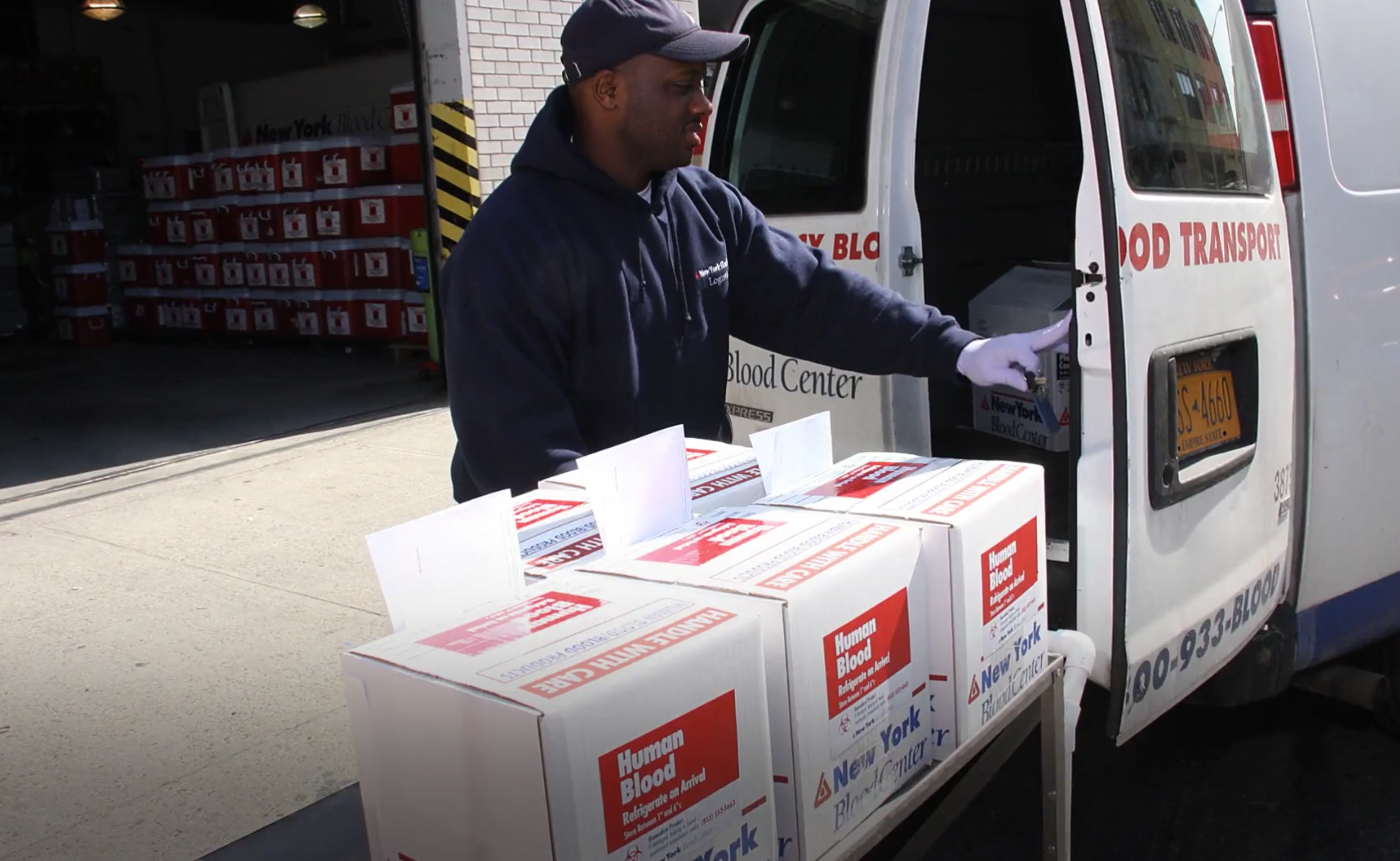 New York Blood Center staff member loading van with blood products for delivery to hospitals and patients in need.