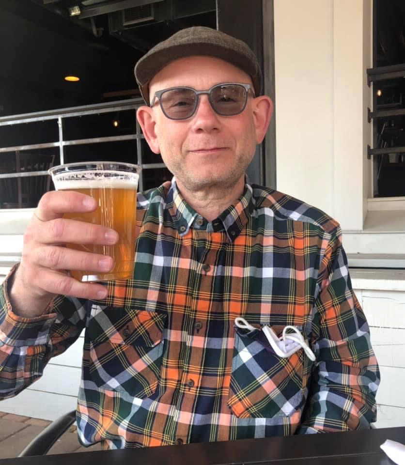 Steven Kfare, a New Jerseyan who started making recurring donations to NYBCe during the COVID-19 pandemic., holding a cup of beer.